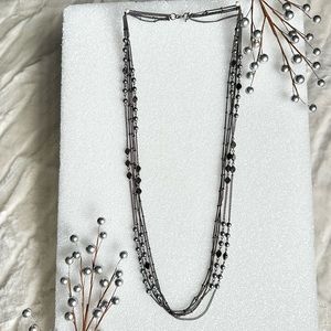 Long multi-strand necklace in dark metal tone with hematite looking beads